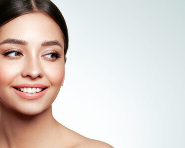 Portrait beautiful young woman with clean fresh skin. Model with great skin health, close up portrait.