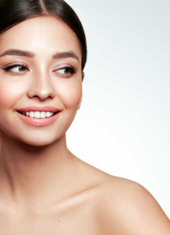 Portrait beautiful young woman with clean fresh skin. Model with great skin health, close up portrait.