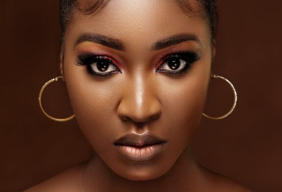 Headshot of a woman staring at the camera after rhinoplasty surgery {{brizy_dc_image_alt imageSrc=